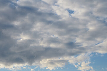 Fototapeta premium Abstract background of white fluffy clouds on a bright blue sky