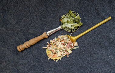 Wonderful Thai herbal tea with Dried lemongrass herb and pandanus on spoons. Organic herbal, Selective focus, Copy space.
