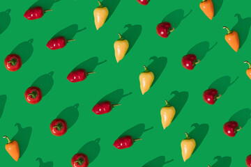 Peppers lay down on green background. Seamless pattern flaylat lay composition, minimal abstract spicy healthy eating concept