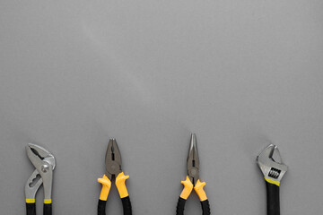 Flat lay composition with construction and home repair tools tools on grey background, space for...