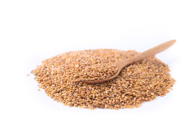 Pile of brown flax seed with spoon on white background