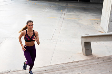 Beautiful athlete woman training outdoors. Young fit woman doing exercise outside