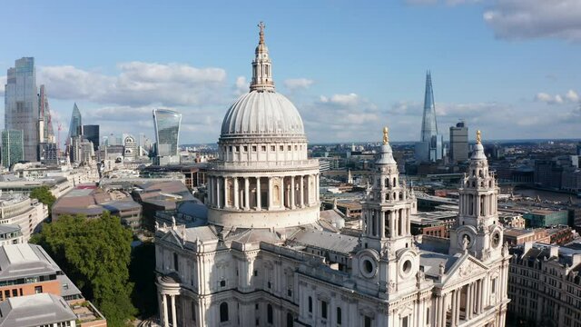 Fly around Saint Pauls Cathedral on Ludgate Hill. Tall modern buildings with glossy glass facades in background. London, UK