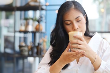 Portrait of Asian woman drinking coffee and have lunch in coffee shop.