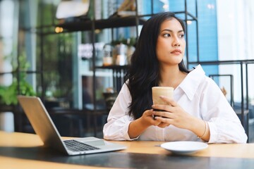 Portrait of Asian woman drinking coffee and have lunch in coffee shop.