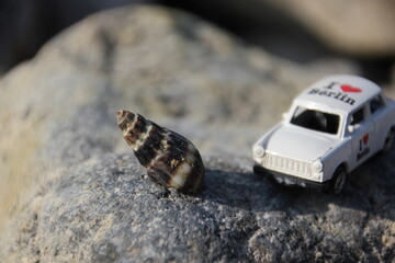 Toy car on the rock. Vintage car.Nature