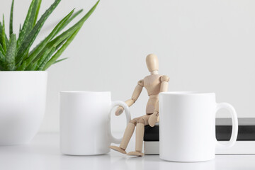 Two mugs mockup with  accessories on white table. Front view. 