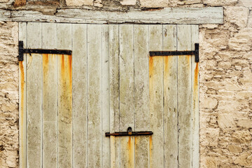 Old wooden door with rusty metal elements. Abstract face