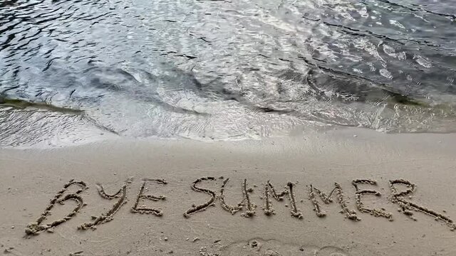 Bye Summer Inscription on the sand on the sea shore.
