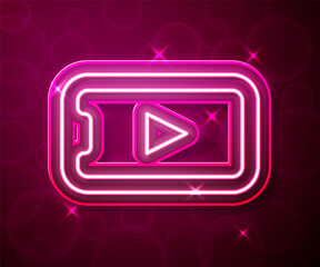 Glowing neon line Online play video icon isolated on red background. Smartphone and film strip with play sign. Vector