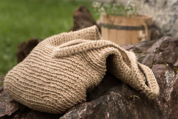 Fototapeta na wymiar Handmade Eco bag crocheted from jute. Picnik in garden