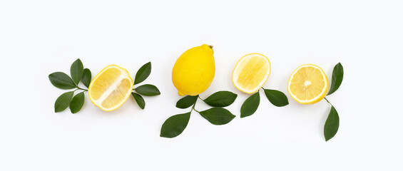 Fresh lemon with green leaves on white.
