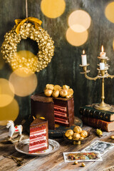 chocolate cake red velvet gold decoration rustic candles garland blur 