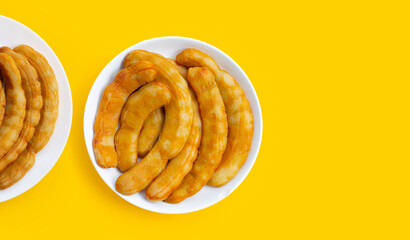 Tamarind pickled fermented on yellow background.
