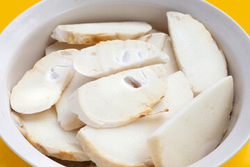 Bamboo shoots in white bowl on yellow background