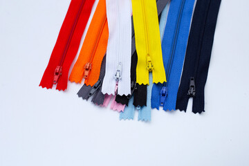 Zippers for clothing on white background.