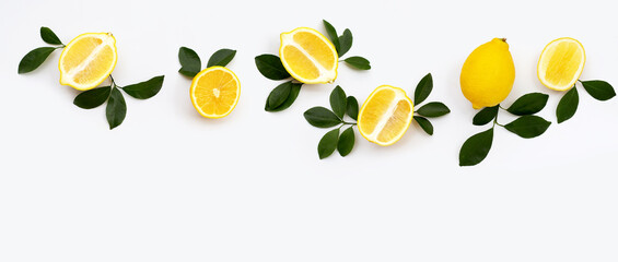 Fresh lemon with green leaves on white.