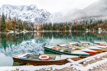 Between autumn and winter. Warm and cold reflections of snow on Lake Fusine.
