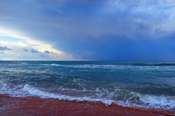 The sea is of immense beauty with waves and thunderclouds in the autumn velvet season.