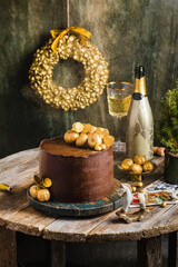 Chocolate cake with gold decor champagne behind rustic style
