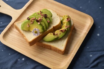 Healthy breakfast with fresh salad, avocado and bread.
