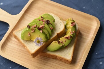Healthy breakfast with fresh salad, avocado and bread.