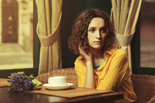 Sad Young Fashion Woman Drinking Tea At Restaurant