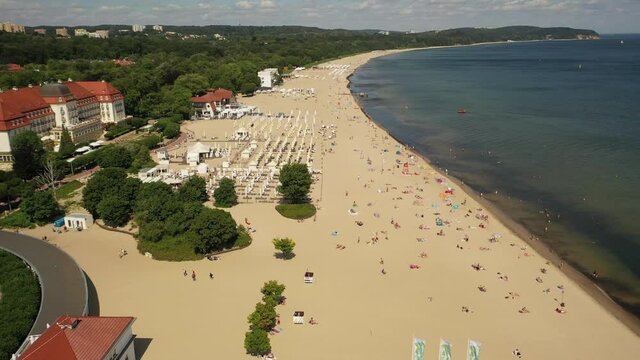 Sopot,Poland,Europe.Aerial 4K video from drone to the beach Sopot, wooden pier (molo) resort old lighthouse,  with marina, yachts, infrastructure, park, promenade and Sofitel Grand Sopot Hotel