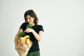 cheerful woman with a package of groceries shopping