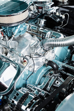 Close up chrome parts in car engine
