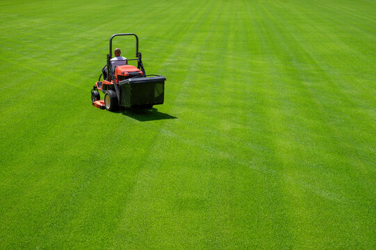 Mowing grass at the football stadium