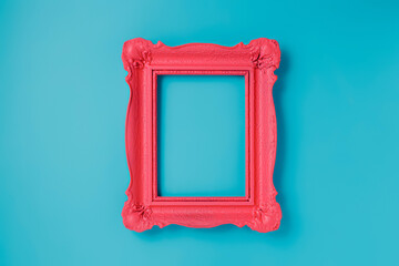 A pink empty frame isolated on the vibrant blue background. Decorative detail, retro inspired...