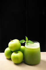 Green detox smoothie or blended juice in glass . Smoothie with kale, green apple and lime Green smoothie with kale, apple and lime