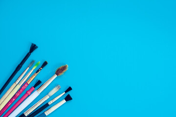 Used paint brushes on blue background