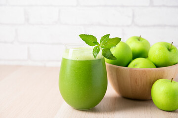 Green detox smoothie or blended juice in glass . Smoothie with kale, green apple and lime Green smoothie with kale, apple and lime