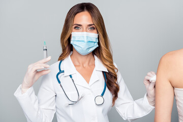 Portrait of attractive woman doc making prick anti mers cov flu influenza isolated over grey pastel color background