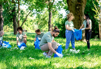 Fototapeta premium Multiethnic group of volunteers with garbage bags cleaning city park.