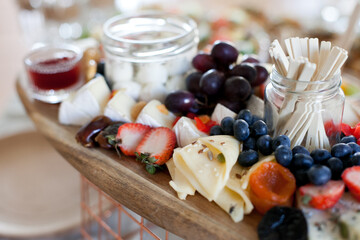 Cheese platter with fruit and honey