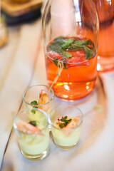 Fototapeta premium Shrimp cocktail and strawberry lemonade on the table at the party