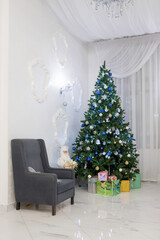 Fototapeta premium Decorated Christmas tree and gift boxes in the living room. Classic christmas