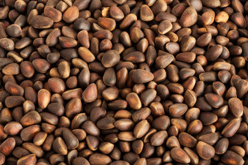 Pine nuts background. Gastronomic background. Healthy snacks. Inshell pine nuts