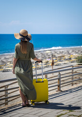 A woman who has come to rest admires the sea.