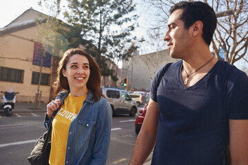 Young woman look directly at the man as she walks