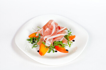 Sliced ham with salad and pepper