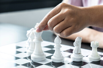 Woman playing chess and thinking strategy plan about crash overthrow the opposite team and...