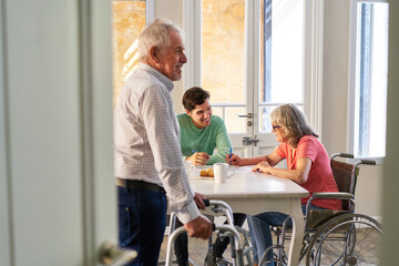 Man and senior citizens with disabilities in assisted living