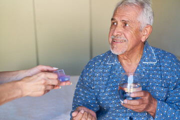 Smiling senior patient receives medication