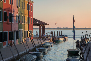 Burano, Venezia. Island corner with colored houses and fishing boats at sunset.