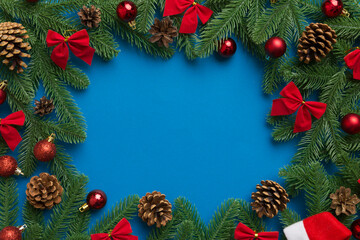 Fototapeta na wymiar Christmas background with fir branches and Christmas decor. Top view, copy space for text