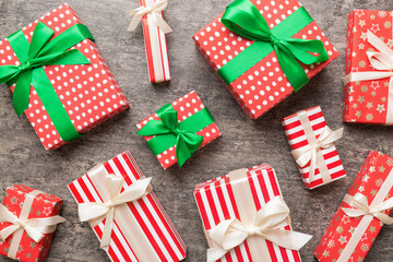 Obraz premium A lot of Christmas gift boxes in colored paper decorated on table, Top view close up. Many present New Year gift
